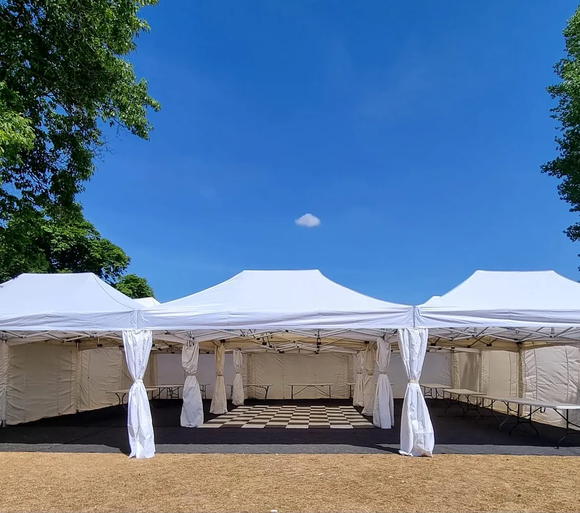 Large white marquee with checkerboard dance floor