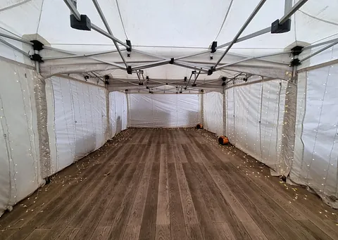 4.5m x 9m marquee with blow heaters and curtain lighting throughout
