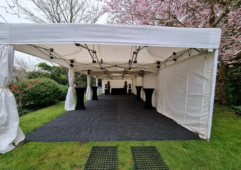 4.5m x 12m Marquee, with flooring, poseur tables and festoon lighting