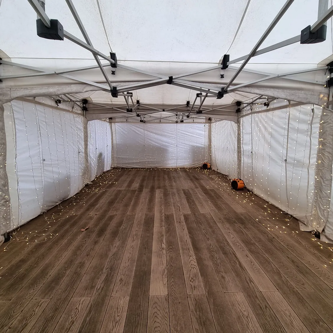 4.5m x 9m marquee with blow heaters and curtain lighting throughout